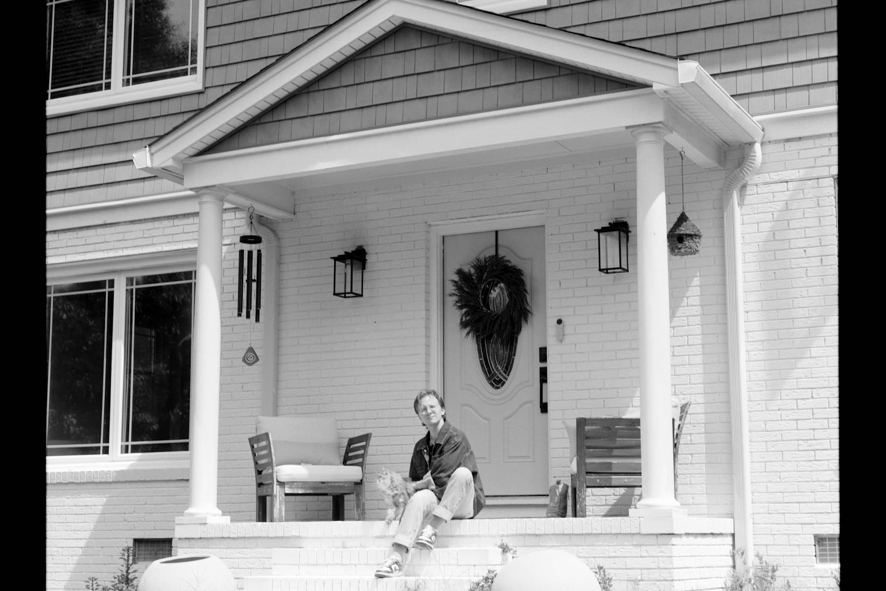 Family visiting on the front steps of their small-town home
